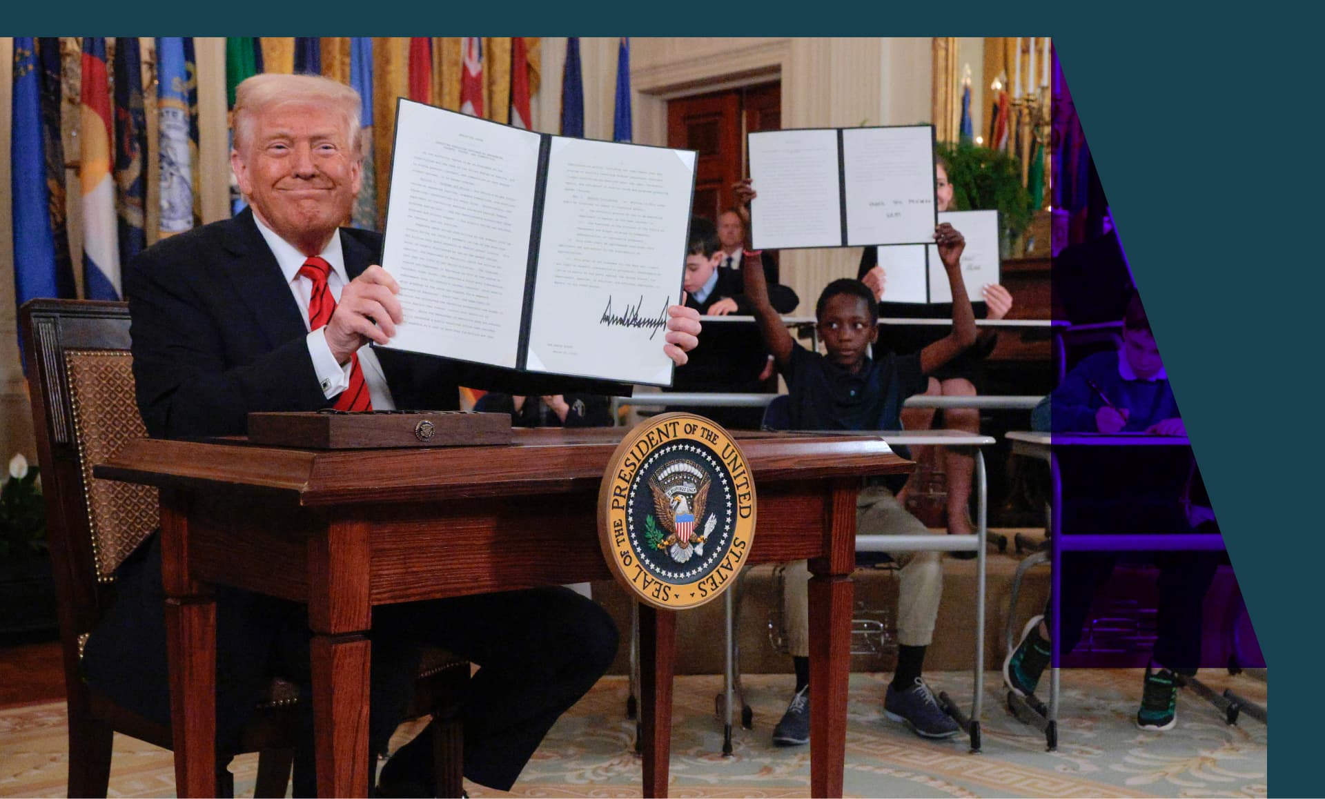 President Donald Trump holding an executive order