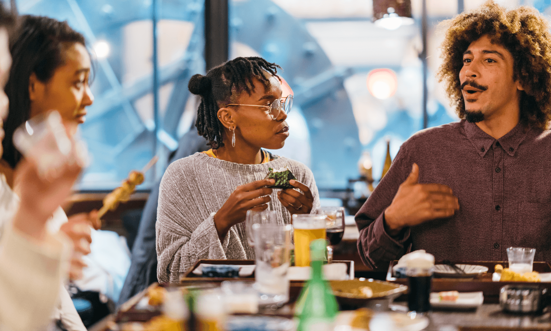 Group of friends talking at a restaurant table.